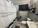 Updated bathroom featuring a tub with curtain and marble tiled floor at 263 Clark Ave, Beech Grove, IN 46107