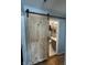 Modern bathroom with a gray vanity, toilet, and barn door entry at 263 Clark Ave, Beech Grove, IN 46107