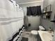 Updated bathroom featuring a tub with curtain and marble tiled floor at 263 Clark Ave, Beech Grove, IN 46107
