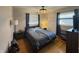 Cozy bedroom featuring hardwood floors, a ceiling fan, and a comfortable bed with bedside tables at 263 Clark Ave, Beech Grove, IN 46107