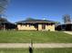 Exterior view of a brick home with green lawn and dark shutters under a clear sky at 263 Clark Ave, Beech Grove, IN 46107