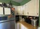 A view into this kitchen features stainless steel refrigerator and white cabinets for lots of storage at 263 Clark Ave, Beech Grove, IN 46107