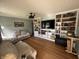 Cozy living room featuring hardwood floors, built-in shelving, and comfortable sofas for relaxation at 263 Clark Ave, Beech Grove, IN 46107