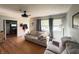 Comfortable living room with hardwood flooring, ceiling fan, and a large window for natural light at 263 Clark Ave, Beech Grove, IN 46107