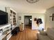Inviting living room with hardwood flooring, built-in shelving, and neutral paint at 263 Clark Ave, Beech Grove, IN 46107