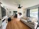 Inviting living room featuring hardwood floors, built-in shelving, a ceiling fan, and lots of natural light at 263 Clark Ave, Beech Grove, IN 46107