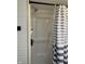 Features a shower with white surround and modern striped shower curtain at 263 Clark Ave, Beech Grove, IN 46107