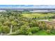 Aerial view of a wooded landscape with homes and a manufacturing plant in the background at 2920 N Buck Creek Rd, Greenfield, IN 46140