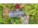 Stunning aerial shot of the home's roofline framed by lush greenery and a vibrant red maple tree at 2920 N Buck Creek Rd, Greenfield, IN 46140