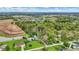 Vibrant aerial image showcasing neighborhood nestled between lush trees, farmland, and a picturesque pond at 2920 N Buck Creek Rd, Greenfield, IN 46140