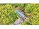 Birds-eye view of charming home's roof and surrounding mature trees with a deck for outdoor enjoyment at 2920 N Buck Creek Rd, Greenfield, IN 46140