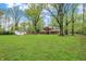 Large backyard with detached garage, fire pit, and mature trees at 2920 N Buck Creek Rd, Greenfield, IN 46140