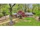 Lovely backyard showcases a vibrant red maple, a lush green lawn, and mature trees, perfect for relaxation at 2920 N Buck Creek Rd, Greenfield, IN 46140