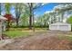This backyard features a detached two car garage and a wooden fence at 2920 N Buck Creek Rd, Greenfield, IN 46140