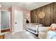 Lovely Bedroom with wooden accent wall, crib, rocking chair, and pink walls at 2920 N Buck Creek Rd, Greenfield, IN 46140