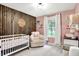 Charming Bedroom with wooden accent wall, crib, rocking chair, window, and changing table at 2920 N Buck Creek Rd, Greenfield, IN 46140