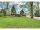 Attractive brick home with lush green lawn and mature trees at 2920 N Buck Creek Rd, Greenfield, IN 46140