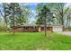 Charming red brick home featuring a spacious front yard with mature trees and an attached garage at 2920 N Buck Creek Rd, Greenfield, IN 46140