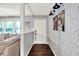 Hallway featuring hardwood flooring, a white entry door, and decorative wallpaper at 2920 N Buck Creek Rd, Greenfield, IN 46140