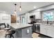 Modern kitchen with stainless appliances, stylish island, granite counters, and a sliding barn door at 2920 N Buck Creek Rd, Greenfield, IN 46140