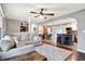 Open concept living space with hardwood floors, view of the kitchen, dining room, and a comfortable sectional sofa at 2920 N Buck Creek Rd, Greenfield, IN 46140