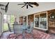 Cozy screened patio featuring a round table and chairs, perfect for outdoor relaxation and entertainment at 2920 N Buck Creek Rd, Greenfield, IN 46140