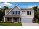 Charming two-story home with a brick and siding exterior, complemented by a well-manicured lawn at 300 Atlas Dr, Lebanon, IN 46052