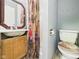 This bathroom includes a sink with vanity, toilet, shower with curtain, and a small mirror above the sink at 306 W Clyde St, Frankton, IN 46044