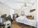 Bedroom with ceiling fan, large bed, and cluttered storage areas, offering potential for personalization at 306 W Clyde St, Frankton, IN 46044