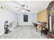 A shot of an open living room featuring gray-toned floors, a ceiling fan, and freshly painted walls at 306 W Clyde St, Frankton, IN 46044