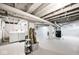 Clean basement with visible pipes and laundry setup, great for storage or future renovations at 316 S Arlington Ave, Indianapolis, IN 46219