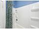 Clean bathroom with a white shower/tub combo and blue accent wall with built in product shelves at 316 S Arlington Ave, Indianapolis, IN 46219
