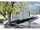 Well-maintained house with light blue siding, landscaped garden, and mature tree at 316 S Arlington Ave, Indianapolis, IN 46219