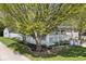 Beautiful house featuring light blue siding, a cozy front porch, and established landscaping at 316 S Arlington Ave, Indianapolis, IN 46219