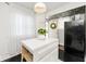Charming kitchen with a central island, black appliances, and ample natural light from a nearby window at 316 S Arlington Ave, Indianapolis, IN 46219