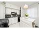Modern kitchen featuring white cabinetry, sleek appliances, and a functional central island workspace at 316 S Arlington Ave, Indianapolis, IN 46219