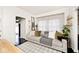 Cozy living room featuring a comfortable sofa, decorative ladder, and sheer curtains for natural light at 316 S Arlington Ave, Indianapolis, IN 46219