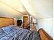 Attic gym features a bed, workout equipment, hardwood floors, and sloped ceilings at 3514 Carson Ave, Indianapolis, IN 46227