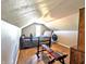 Attic gym features a bed, workout equipment and hardwood floors at 3514 Carson Ave, Indianapolis, IN 46227