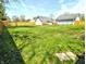 Expansive backyard featuring lush green grass and a sturdy wooden fence, perfect for outdoor enjoyment and recreation at 3514 Carson Ave, Indianapolis, IN 46227