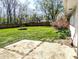 View of a large, grassy backyard with a wooden fence and a concrete patio area, perfect for outdoor activities and relaxation at 3514 Carson Ave, Indianapolis, IN 46227