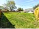 Expansive fenced backyard with mature trees, providing privacy and shade for outdoor enjoyment, along with room for gardening at 3514 Carson Ave, Indianapolis, IN 46227