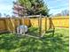 Fenced backyard area featuring a small dog house inside of a framed structure, ideal for pets and outdoor activities at 3514 Carson Ave, Indianapolis, IN 46227