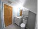 Compact bathroom with a modern vanity and toilet under a slanted ceiling, maximizing space and functionality at 3514 Carson Ave, Indianapolis, IN 46227