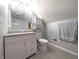 Well-lit bathroom featuring a modern vanity, toilet, and built in storage for a functional layout at 3514 Carson Ave, Indianapolis, IN 46227