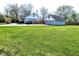 Home and detached garage featuring a well-maintained lawn and fenced yard at 3514 Carson Ave, Indianapolis, IN 46227