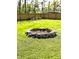 Backyard fire pit featuring a circular stone design, perfect for outdoor gatherings and cozy evenings by the fire at 3514 Carson Ave, Indianapolis, IN 46227