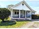 Inviting front porch with seating and hanging plants on a charming home at 3514 Carson Ave, Indianapolis, IN 46227