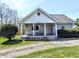 Charming front porch with seating area and decorative hanging plants at 3514 Carson Ave, Indianapolis, IN 46227