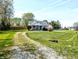 Inviting home on a sunny day, featuring a long driveway and lush green lawn at 3514 Carson Ave, Indianapolis, IN 46227